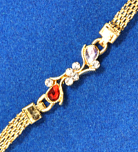 Golden Rakhi Bracelet with Red and White Stones